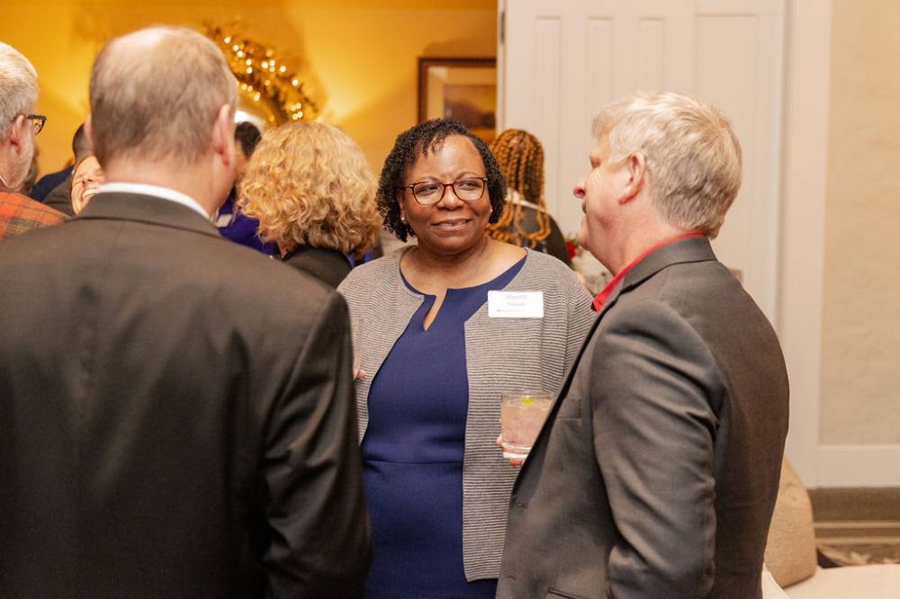 Woman looking over at other party attendee as they engage in conversation